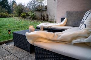 two couches sitting on a patio with candles at TRUTH - Winternest - Smart TV - Terrasse - Kamin in Brilon