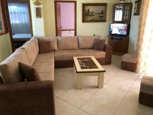 a living room with a couch and a coffee table at Quality home in Sarandë