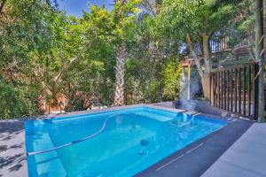 a swimming pool in a yard with trees at Wilderness@OceanView in Wilderness