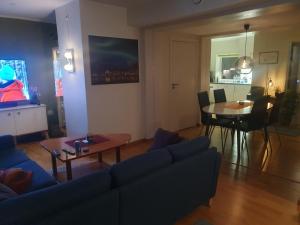 a living room with a couch and a table at Top Apartment in Tromsø