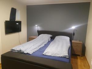 a bed with two pillows on it in a bedroom at Top Apartment in Tromsø