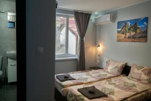 a small bedroom with a bed and a window at Къща за гости Белоградчик in Belogradchik +76 photos