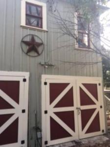 two red and white garage doors on a house at Cozy urban aprtmt in San Antonio