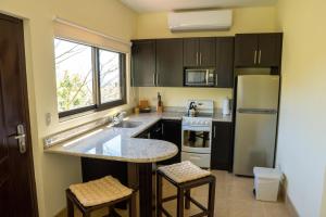 a kitchen with a sink and a refrigerator at Vida Mountain Resort & Spa Adults Only in San Ramón