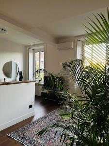 a living room with a couch and a plant at LOFT MANZONI 37 in Cremona +45 photos