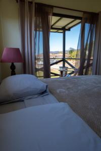 a bedroom with a bed and a window with a view at Vida Mountain Resort & Spa Adults Only in San Ramón