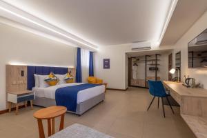 a hotel room with a bed and a desk at Premium Inn Mombasa City in Mombasa +41 photos