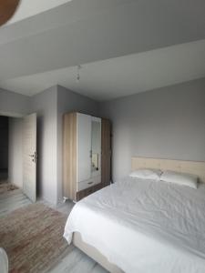 a bedroom with a large white bed and a cabinet at Dilaver-Apart in Istanbul