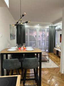 - une salle à manger avec une table et des chaises en bois dans l'établissement House Inn, à Pirot