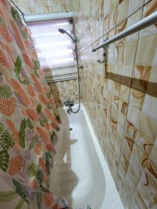 a bathroom with a bath tub and a window at GHouse in Adentan +39 photos
