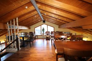 a dining room with wooden tables and chairs at Zimmer Mamma Mia in Bürchen +21 photos