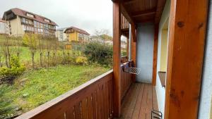 an open door to a porch with a view of a yard at Lipno Pearl 2 in Lipno nad Vltavou