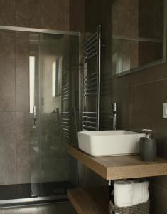 a bathroom with a sink and a glass shower at Serendipity room & relax in Palermo +70 photos