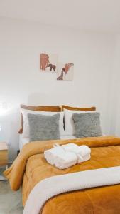 a bed with two white towels on top of it at OCASSO JARDIN APARTAMENTO TURPIAL in Jardin