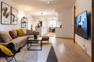 uma sala de estar com um sofá e uma mesa em Stylish Scandinavian Suite - Sauna, Harbor & Free Parking em Helsinque