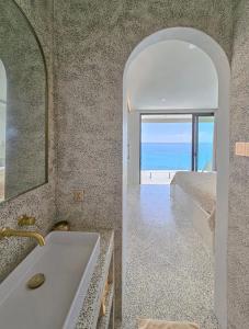 a bathroom with a sink and a mirror at Villa Endless - Two Bedroom Family Suite - Beachfront Luxury - Bingin Beach in Uluwatu