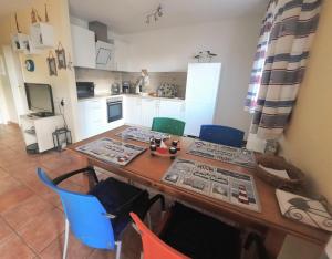 a kitchen with a wooden table and blue chairs at Sonne in Neddesitz
