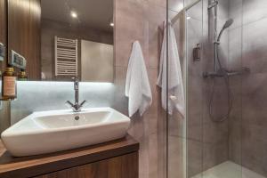 a bathroom with a sink and a shower at Rent like home - Bruna 2 in Warsaw