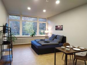 a living room with a bed and a table at Andris Apartments in Stuttgart