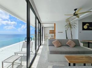 a living room with a couch and a view of the ocean at Villa Endless - Two Bedroom Family Suite - Beachfront Luxury - Bingin Beach in Uluwatu