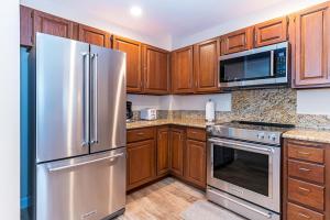 a kitchen with wooden cabinets and stainless steel appliances at 47 McCloud - Upper Unit 3 Bedrooms in Incline Village