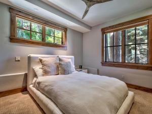 a bedroom with a large bed and two windows at A Touch Of Tuscany In a Lake Tahoe Estate in Incline Village