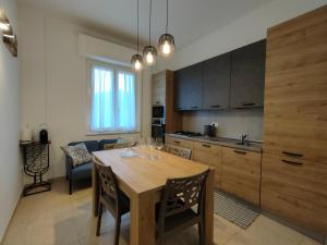 a kitchen and dining room with a wooden table at Casa Ewa - Centro Pesaro in Pesaro