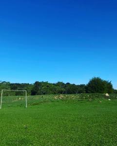 a soccer goal in a field of green grass at Sítio morada nova in Contagem