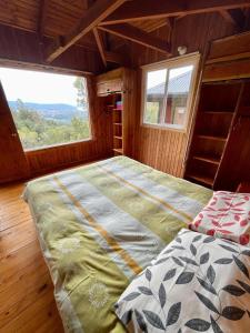 a large bed in a room with a window at Cabañas Kalfvgen in Valdivia +67 photos