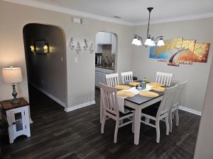 a dining room with a white table and chairs at KING BED! Walk To AT&T Stadium, Globe Life in Arlington