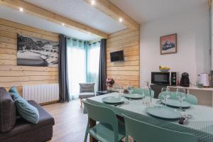 a living room with a table and a couch at L'horizon studio in Cauterets
