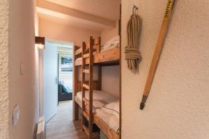 a room with a bunk bed in a house at L'horizon studio in Cauterets