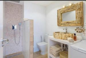 a bathroom with a sink and a shower with a mirror at Sea light in Puerto del Carmen