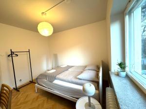 a bedroom with a bed and a window at SimpleStay Airport in Vantaa