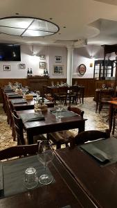 a row of tables in a restaurant with wine glasses at Albergo Roma in Valdagno