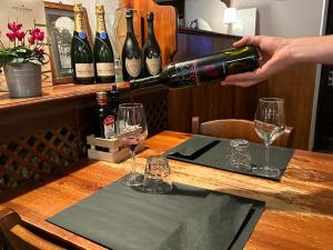 a person pouring a glass of wine on a table at Albergo Roma in Valdagno