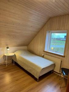 a small bedroom with a bed and a window at House in Billund in Billund