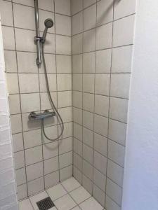 a shower with a shower head in a bathroom at House in Billund in Billund