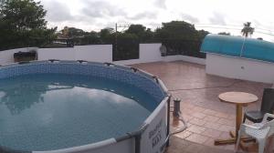 a large swimming pool sitting on top of a house at La Reserva de UBA in El Socorro