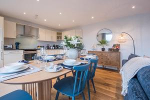 Una cocina y un comedor con mesa y sillas. en Beautiful Central Tenby Apartment with free parking, en Tenby