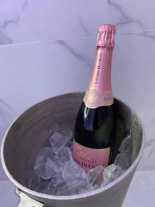a bottle of champagne in a bucket of ice at Maison avec Jacuzzi - Louvres proche Roissy CDG - Paris in Louvres