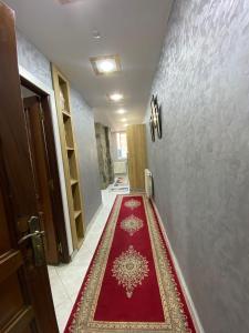 a hallway with a red carpet on the floor at la paix in Ifrane