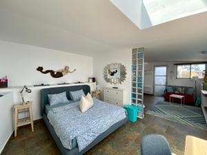 a bedroom with a bed and a living room at Villa Oasis La Paz - Acaymo Loft - ADULTS ONLY - in Puerto de la Cruz