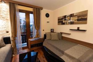 a bedroom with a bed and a window at Apartman W Residence in Kopaonik