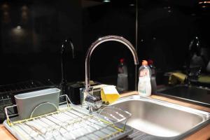 a kitchen sink with a dish drying rack in it at Apartman W Residence in Kopaonik +33 photos