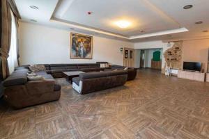 a large living room with couches and a flat screen tv at Apartman W Residence in Kopaonik