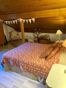 a bedroom with a large bed with a wooden ceiling at Chez papa et maman in Eaux-Bonnes