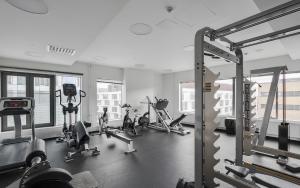a gym with treadmills and exercise equipment in a building at Waterfront 1 Bedroom Skyscraper Suite - 18th Floor - Free Garage Parking in Helsinki