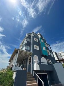 a blue building with stairs in front of it at 5 Soles II in Pinamar