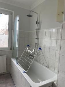 a bathroom with a bath tub with a shower at Im Herzen von Haltern am See in Haltern